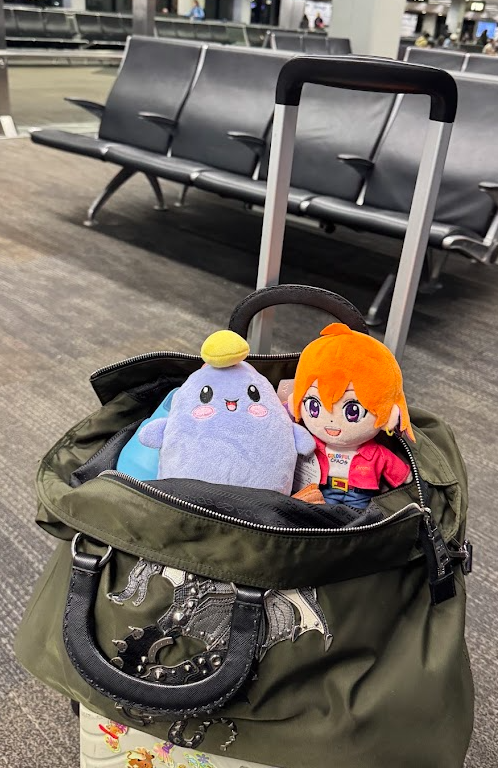 Plushies exploring an airport gate under a dinosaur decoration